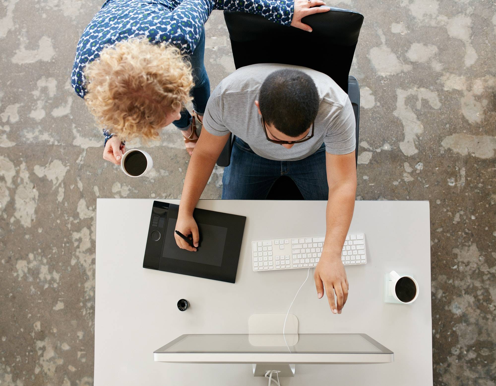 Two young people doing graphic design work