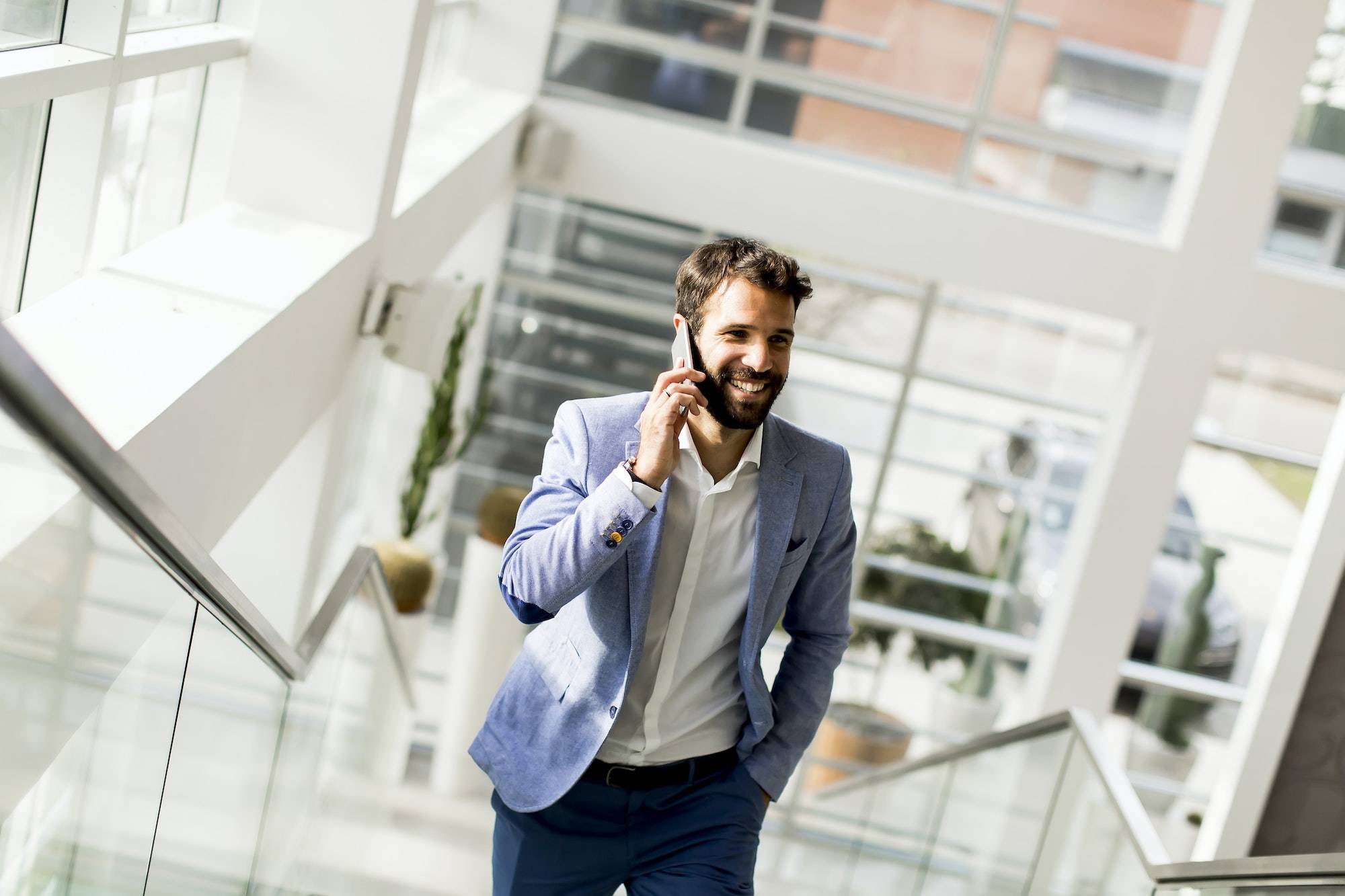 Handsome businessman in suit using the phone